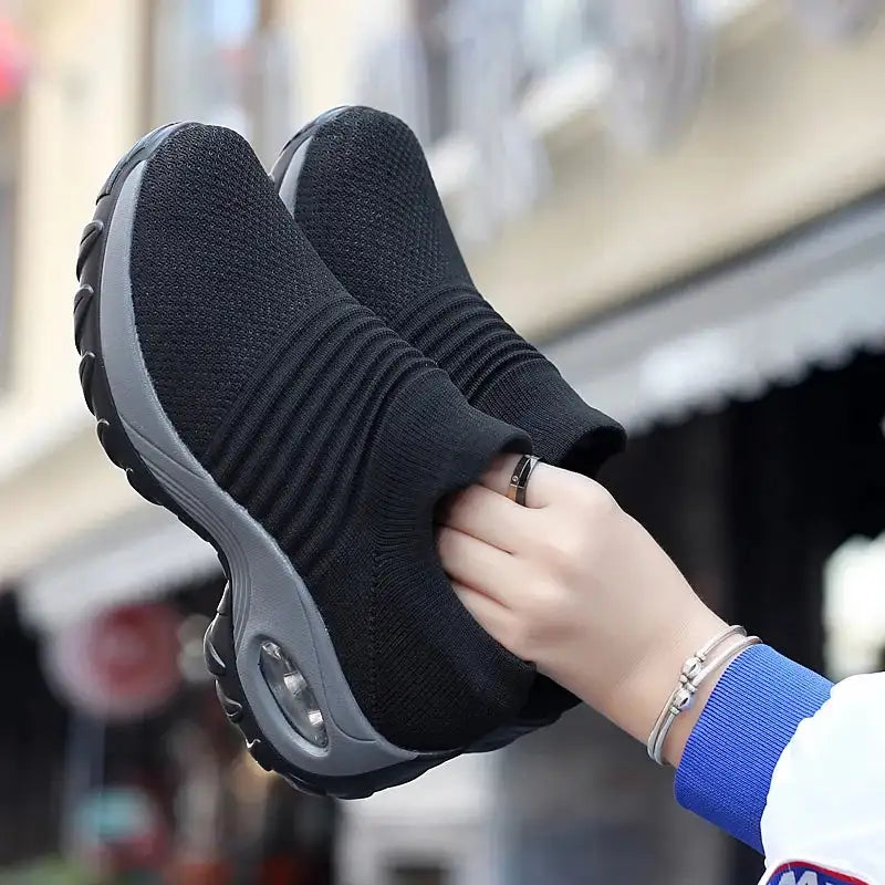 "Women Sneakers Fashion Breathable Walking Mesh Platform Shoes in black with slip-on design and cushioned sole for gym or casual wear."