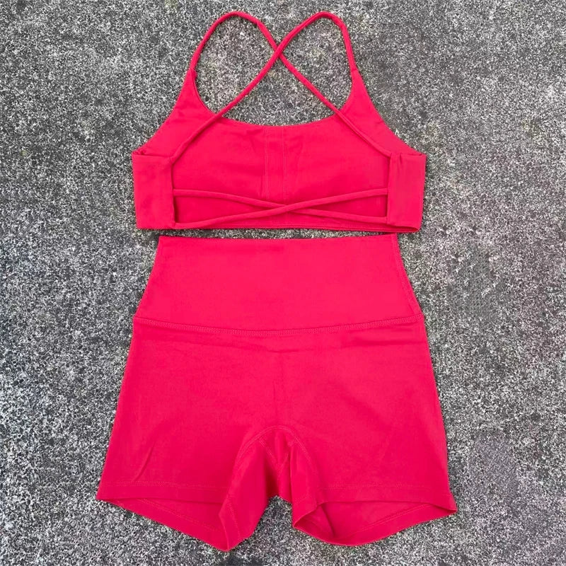 Red two-piece outfit with a crop top and shorts on a gray surface