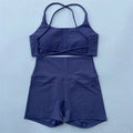 Purple swimsuit with a top and shorts on a light blue background