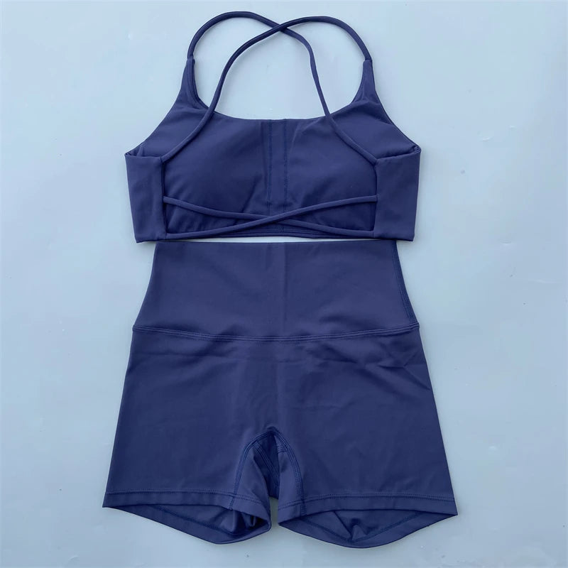 Purple swimsuit with a top and shorts on a light blue background