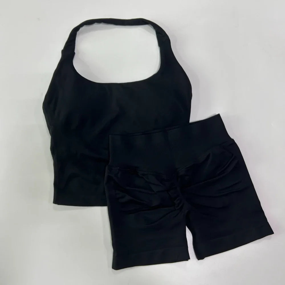 Black tank top and shorts set on a light gray background