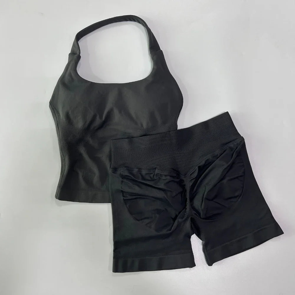 Black tank top and shorts set on a light gray background