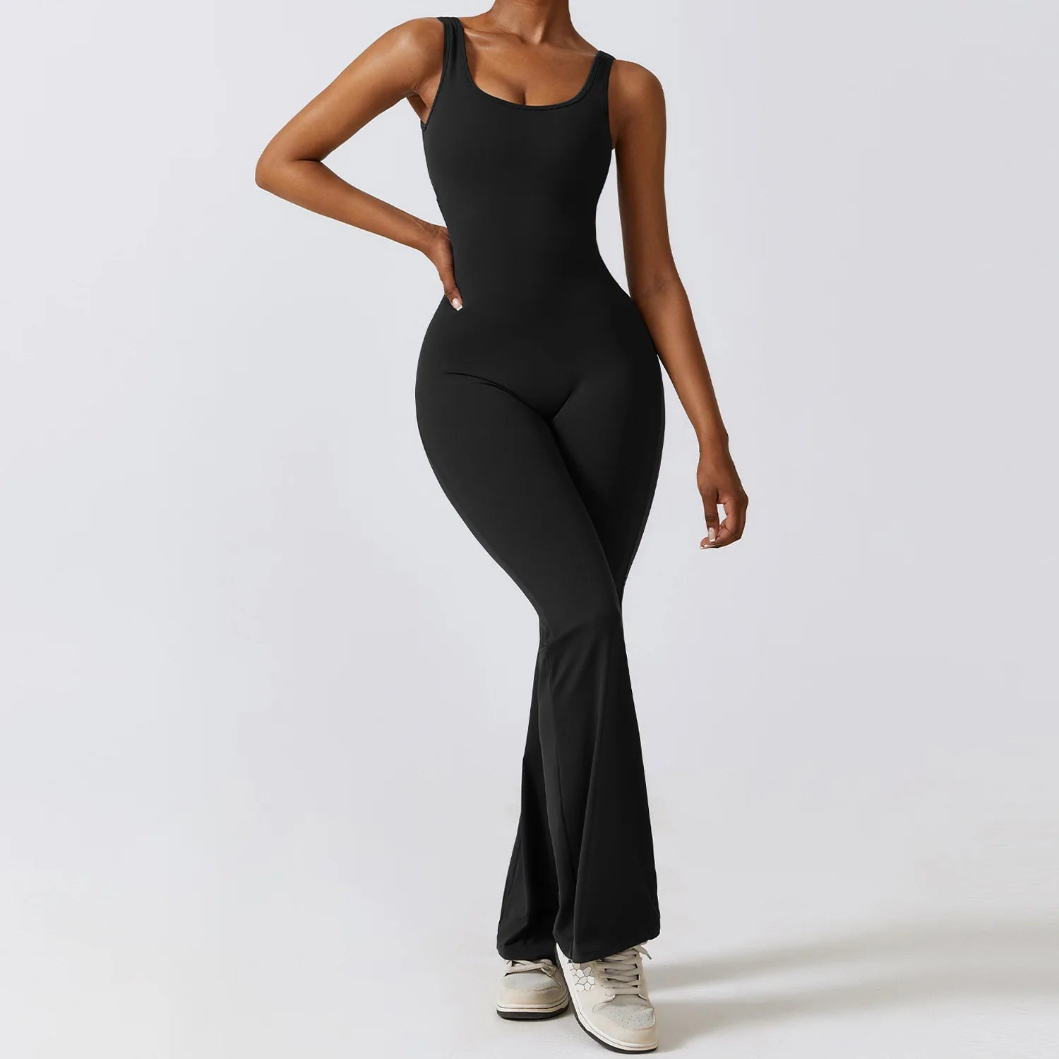 Person wearing a black bodysuit on a white background