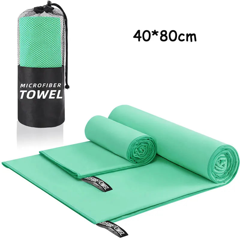 Green microfiber towel set with carrying case on a white background