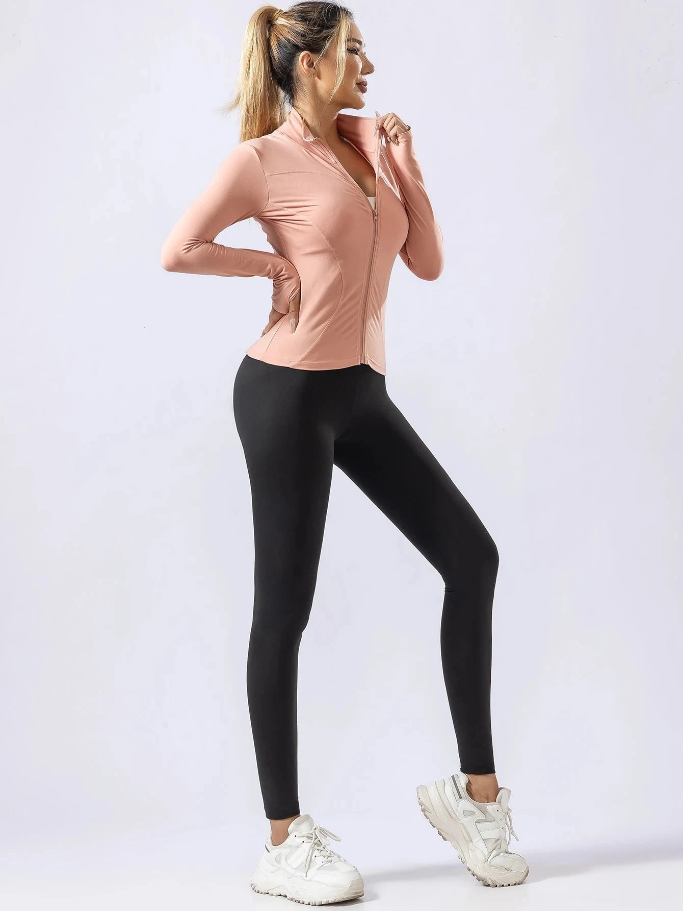 Women's pink long-sleeve quick-dry yoga top and black leggings set, ideal for cold-weather workouts and professional gym wear.