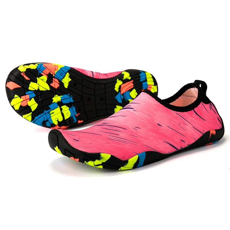 Bright pink unisex aqua shoes with colorful non-slip soles, perfect for beach and outdoor activities.