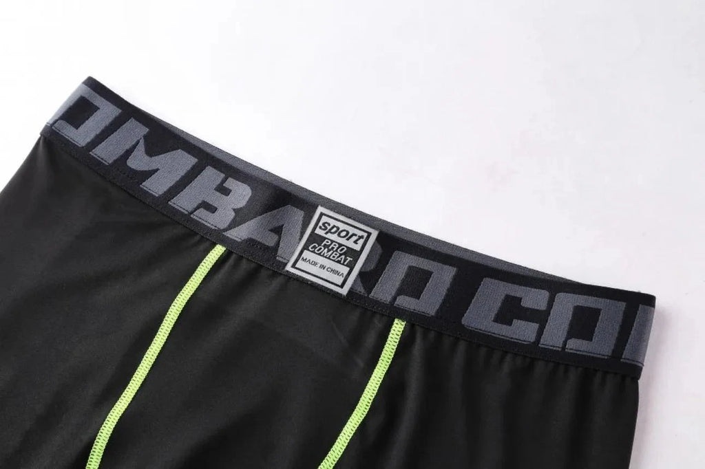 Elastic waistband with 'COMBAT' branding on black Men Bodybuilding Sportswear Clothes Fitness Suit pants for secure fit.