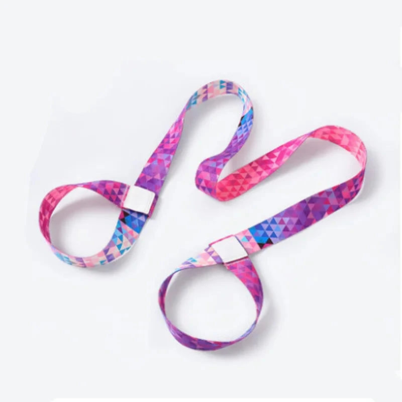 Pink and purple geometric adjustable yoga mat strap with reinforced loops. Designed for mat carrying, stretching, and yoga practice support.