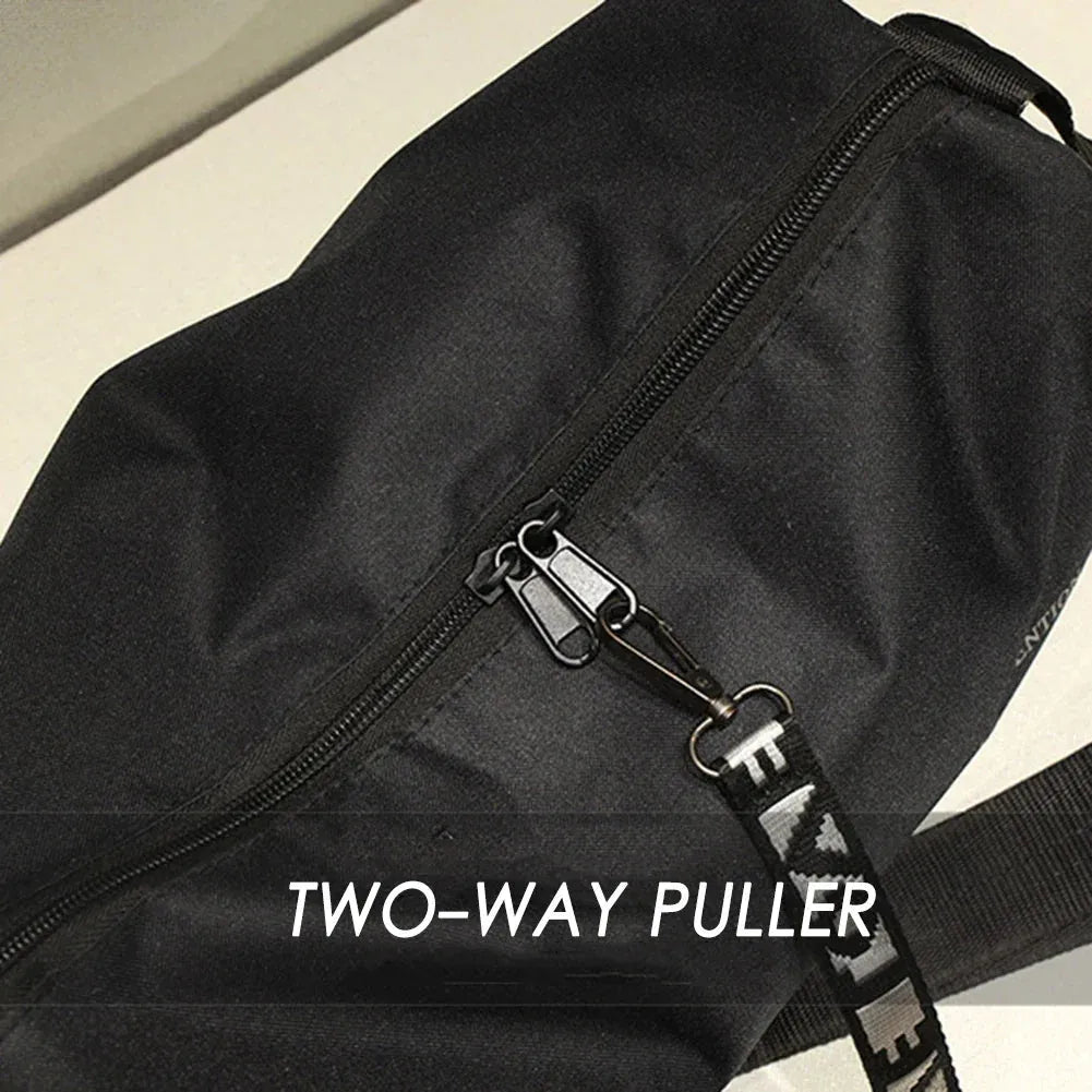 Close-up of two-way zipper pull on black fitness travel bag, enhancing accessibility and style with LOVE printed strap detail.