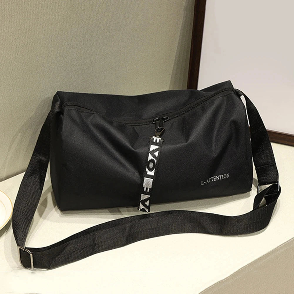 Compact multifunction fitness travel handbag in black nylon with durable shoulder strap, perfect for unisex outdoor workouts.