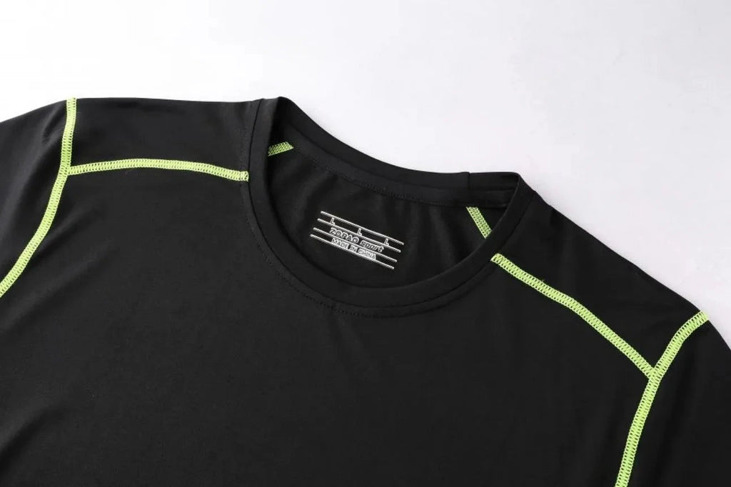 Close-up of neckline on black Men Bodybuilding Sportswear Clothes Fitness Suit with neon green stitching and brand label.
